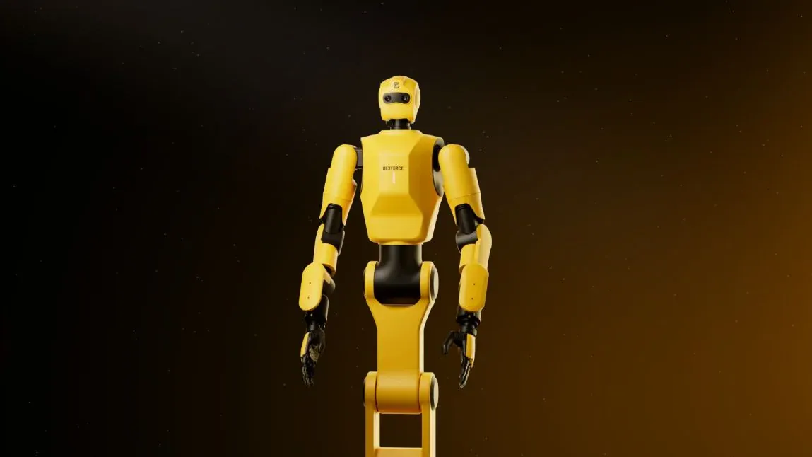 Yellow humanoid robot with black joints, photographed against a dark background.